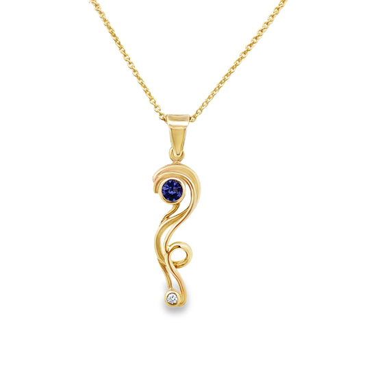 An elegant gold pendant with a blue gemstone in the center, suspended on a gold chain.